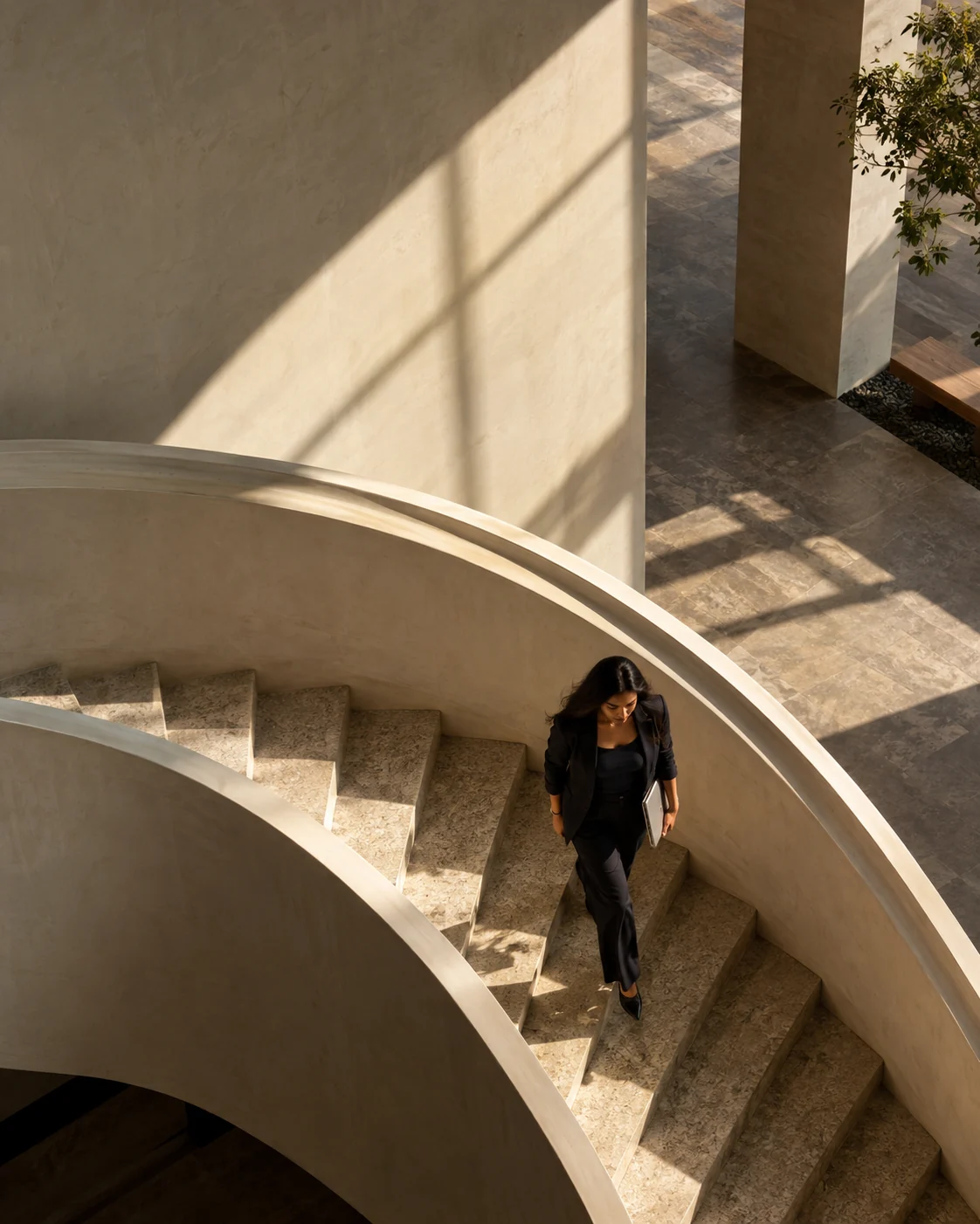 A business owner walking up sunlit concrete stairs